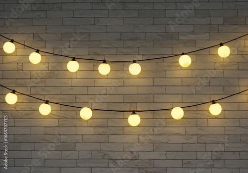 Two strings of glowing spherical lights hang against a textured white brick wall, creating a warm and inviting ambiance.