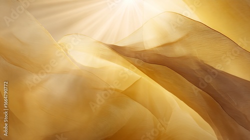 Flowing sheer fabric forms abstract waves illuminated by bright golden sunlight