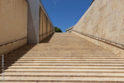 The limestone stairs by the gate to Valletta in a sunny day