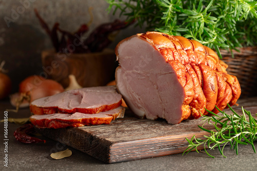 Canvas Print Smoked pork ham on a kitchen table.