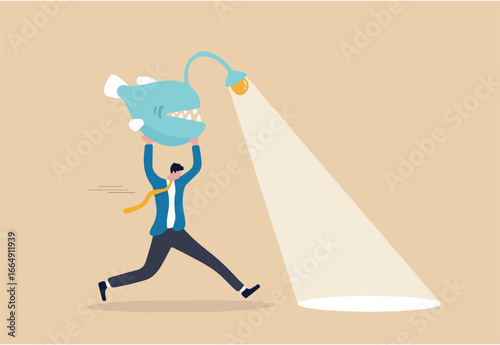 Business direction, flashlight to see opportunity, spotlight to bright success future, leadership and aptitude to solve problem, smart businessman carry angler fish use as flashlight to guide the way.
