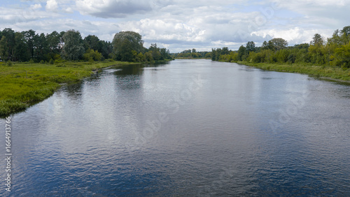 Serene River and Lush Green Landscape in Nowy Lubiel, Poland