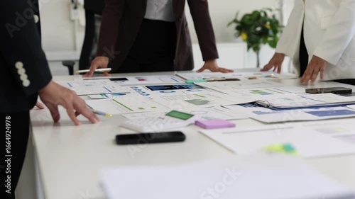 Business team analyzing data and developing strategies in office meeting.