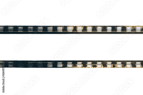 Two parallel horizontal rows of film strips, faded and distressed, against a black background.  Color variations and imperfections are visible on the strips