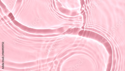 Abstract image of pale pink liquid with concentric ripples and subtle light reflections