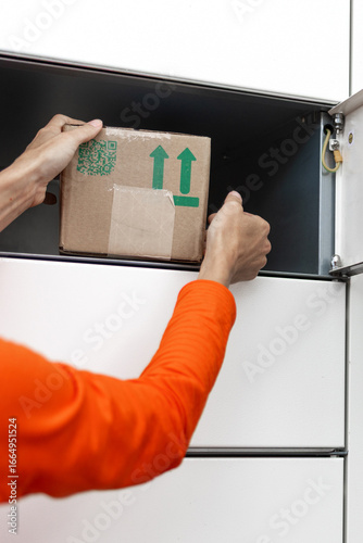 Parcel being delivered via smart locker. Contactless delivery, package pickup, self service parcel collection, ecommerce shipping, modern postal logistics.