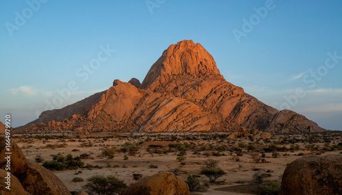 he Spitzkoppe in the desert. A group of bald granite peaks between Usakos and Swakopmund in the Namib desert of Namibia in the late afternoon. It isThe Spitzkoppe.