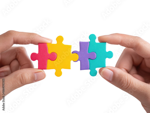 Two hands hold three colorful puzzle pieces together