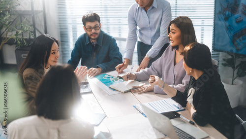 Asian professional woman presentation with business team working together meeting at indoor modern office
