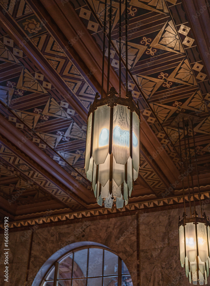 Obraz premium Red and Gold Geometric Pattern Ceiling with White Glass Panel Ceiling Lights.