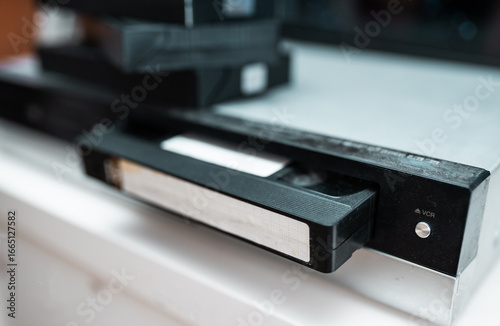 Close up of a hand holding a videotape.