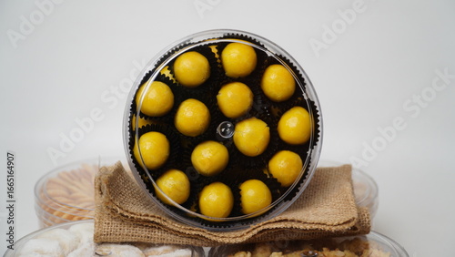 Traditional Indonesian Nastar cookies packed in a clear plastic jar. Isolated on a white background. Perfect for use in food blogs, recipe books, festive promotions, or product packaging mockups