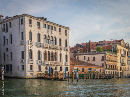 Venetian palaces with gondolas at sunset