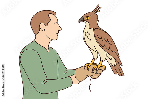 Falconer holding a hawk on his gloved hand during a demonstration in a natural setting