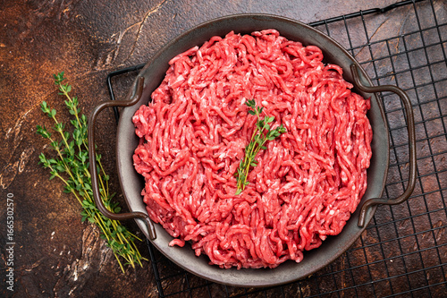 Obraz na płótnie Fresh Raw pork and beef ground mince meat, mincemeat in a plate on brown background