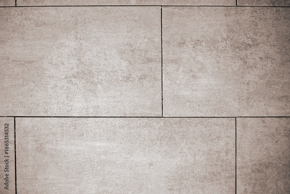 Fototapeta premium Close-up of uniformly laid large format ceramic tiles with straight lines without grout