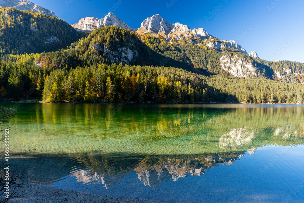 Fototapeta premium Italy, Trentino, Lago di Tovel - 24 October 2021 - The crystal-clear Lake Tovel and the fantastic Trentino woods