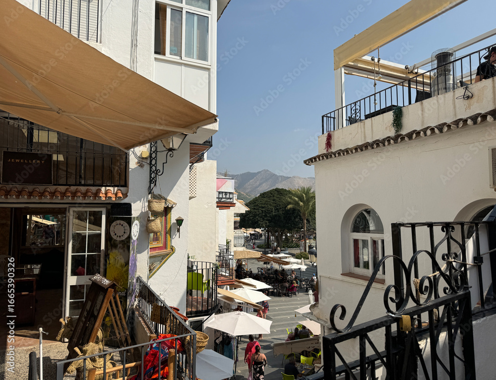 Fototapeta premium boutiques and stairway in the centre of the old town of Mijas, a historic town in the mountains of Andalusia between Marbella and Malaga, Fuengirola, Benalmadena, Costa del Sol, Spain