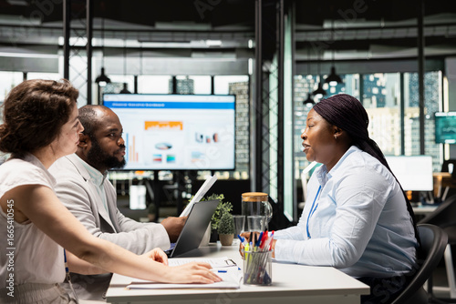 Tableau sur toile HR department team discussing with black woman about career opportunity, selecting candidates during job interview session in a corporate office