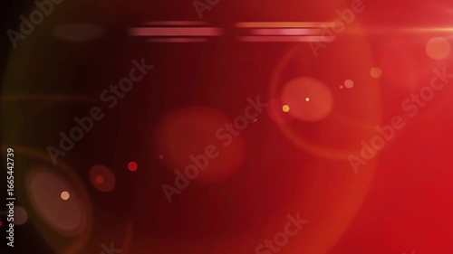 Warm red camera lens lights reflected on black screen, reflections of light cloned severally on a photoshoot or filming project