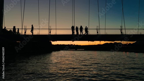 The last light of day fades behind the Humber River Pedestrian Bridge