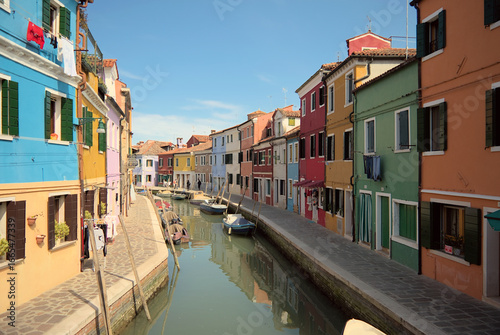 Colorful canal street with boats in Burano Venice