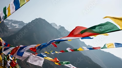 Colorful Tibetan Buddhist prayer flags flutter high in majestic Himalayan mountains