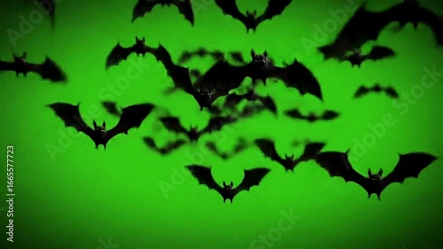 Spooky halloween background featuring flying bats silhouettes against a dark green sky, creating a sense of fear and mystery for holiday celebration