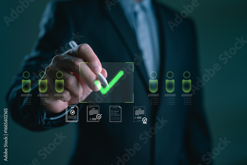 Fotografie Businessman selecting a candidate with a green check mark on a virtual interface, concept of hiring approval, digital recruitment system, employee evaluation and HR management technology