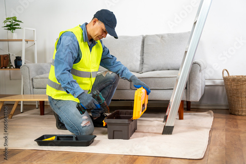 Handyman in Action: An adept handyman in a reflective vest prepares his tools at the ready, embodying the essence of a reliable craftsman.