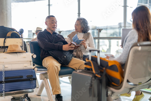 Wallpaper Mural Senior asian couple sitting with luggage checking passport planning trip showing travel preparation at airport, retirement lifestyle enjoying international travel, safe travel, elderly trip insurance Torontodigital.ca