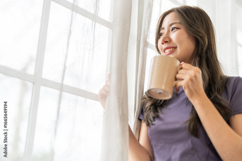Portrait of smiling happy cheerful beauty pretty asian woman relaxing drinking and looking at cup of hot coffee or tea.Girl felling enjoy having breakfast in holiday morning vacation at home Portrait of smiling happy cheerful beauty pretty asian woman relaxing drinking and looking at cup of hot coffee or tea.Girl felling enjoy having breakfast in holiday morning vacation at home