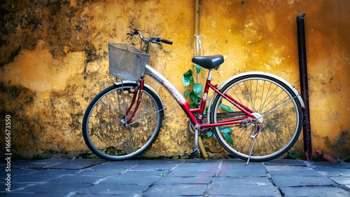 Vintage bicycle parked against weathered wall