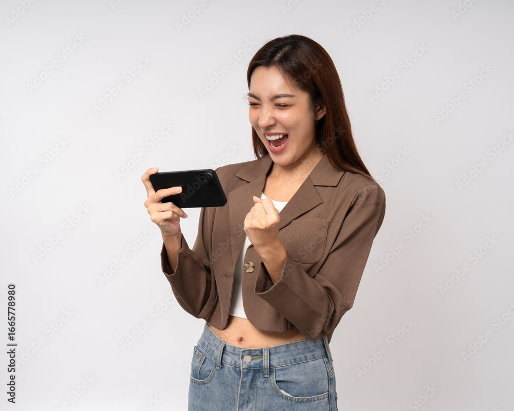 Pretty young asian woman using cellphone standing on isolated white background. Happy Excited Beautiful young asian shopping online payment with mobile phone. Playing game on smartphone Pretty young asian woman using cellphone standing on isolated white background. Happy Excited Beautiful young asian shopping online payment with mobile phone. Playing game on smartphone
