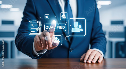 Businessman selects virtual option marked qualified using touchscreen in office setting with blue suit