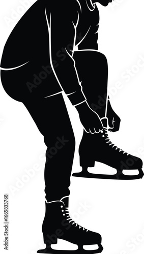 Silhouette of a person tying ice skates, preparing for winter sport activity at an ice rink