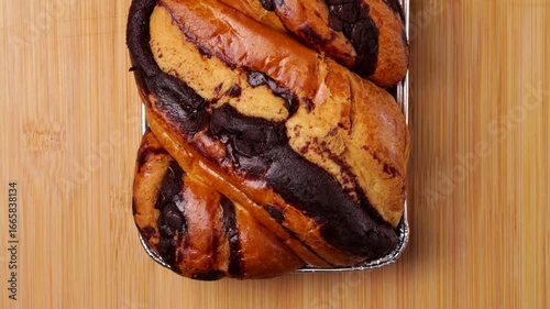 Delicious chocolate babka bread resting on wooden table