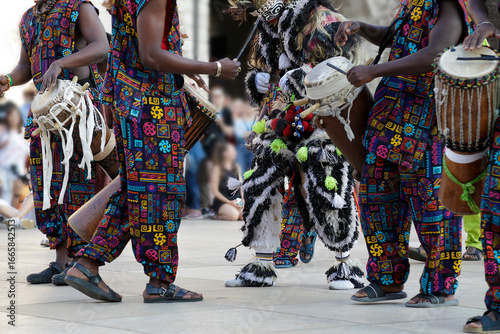 Men playing playing drums and wearing one of the traditional costume from Dakar, Senegal