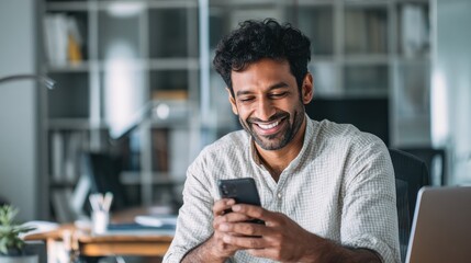 smiling indian business man using cellphone apps working in office happy arab professional businessman holding mobile phone checking finance banking application technology no logos no brands ar 169