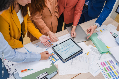 Business meeting showcases agile brainstorming with data analysis charts on tablets. Financial growth prediction strategy through predictive analytics and data-driven insights for strategic business 