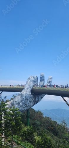 фотографія Golden Bridge held by giant stone hands, Ba Na Hills, Da Nang, Vietnam”