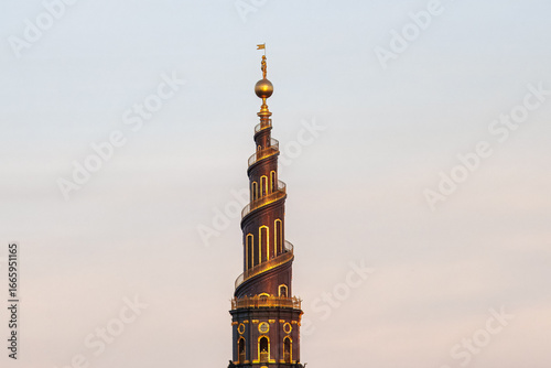 Photography The iconic spiral tower of the Church of Our Saviour in Copenhagen, Denmark highlighted by sunset sun light