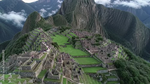 High angle view of ancient Machu Picchu ruins surrounded by mountains and vegetation