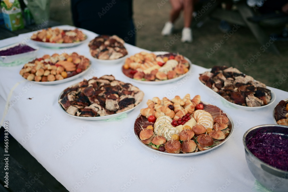 Obraz premium Gourmet Array A Delicious Spread of Savory Pastries and Grilled Delights