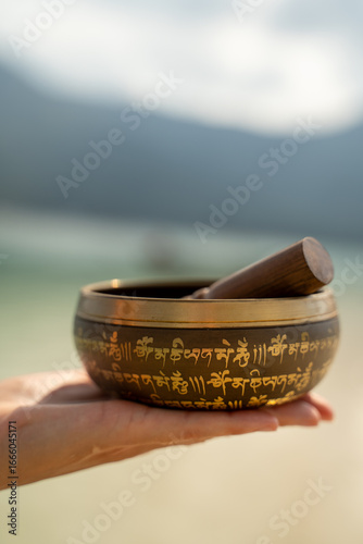 Person holding a singing bowl