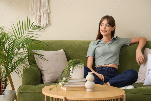 Young woman sitting on gree...