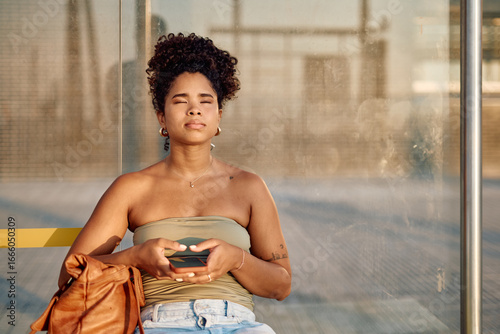 Photography Serene young woman meditating while waiting for public transportation, finding p