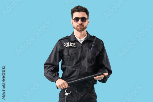 Male police officer with ba...