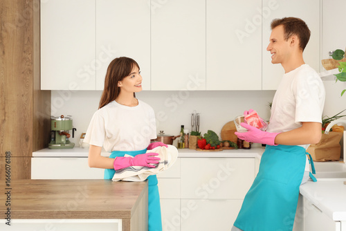 Young couple washing dishes...