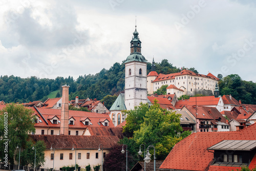 Wallpaper Mural Picturesque european old town of Skofja Loka with church tower, red rooftops and historic buildings surrounded by green hills. Slovenia Torontodigital.ca